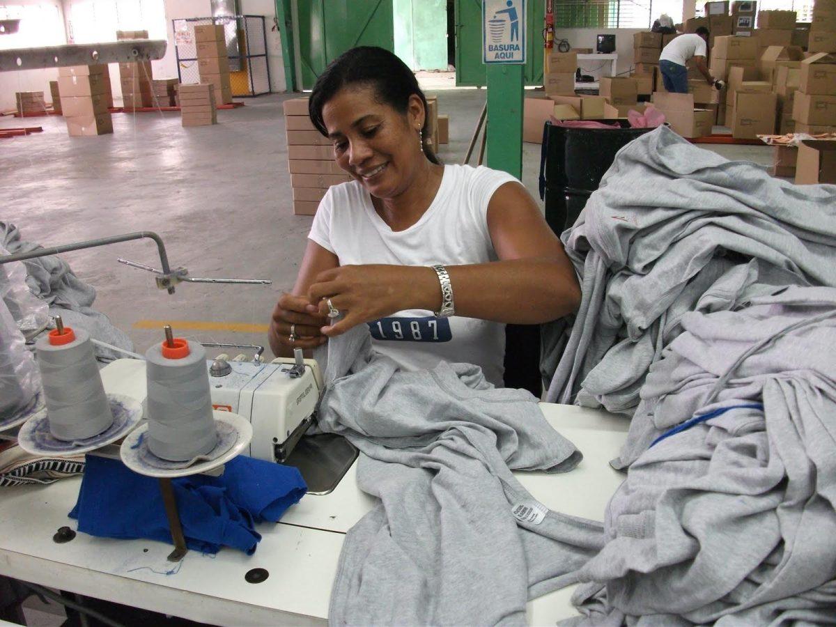 An Alta Gracia Apparel seamstress sews collegiate apparel in the company factory in Villa Altagracia, Dominican Republic.