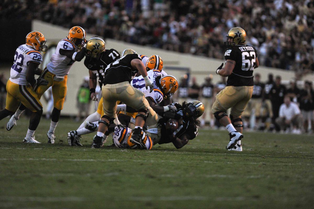 LSU senior linebacker Kelvin Sheppard (11) and freshman defensive back Sam Montgomery (99) take down Vanderbilt quarterback Larry Smith (10) on Saturday.