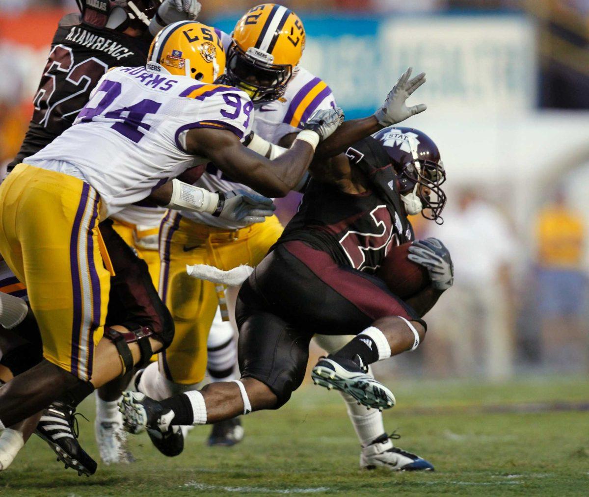 Mississippi State running back LaDarius Perkins (27) is brought down by LSU defensive end Kendrick Adams (94) during the first half of an NCAA college football game in Baton Rouge, La., Saturday, Sept. 18, 2010.