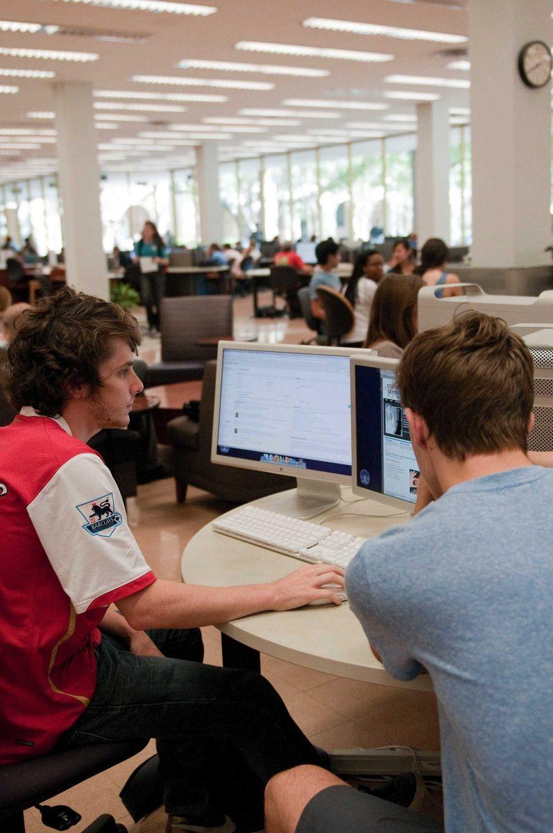 Marketing senior Colin Ash, left, and communication studies junior Hal Lambert edit their music website www.stereogumbo.com in Middleton Library.