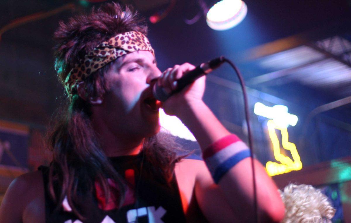 Paul Barrios, lead singer of Sue Johanson&#8217;s, performs during a show at Reggie&#8217;s. The band planned to split up after graduation but opted to continue playing.