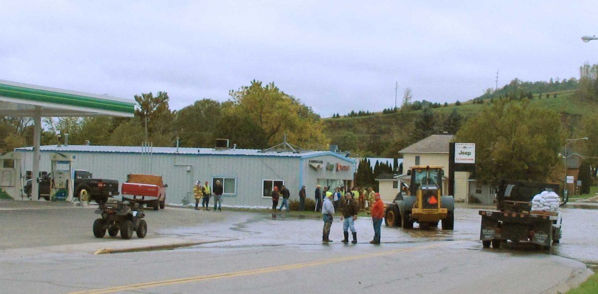 Emergency workers look at flood waters from the Trempealeau River Friday, Sept. 24, 2010, in Arcadia, Wis. Emergency officials evacuated 343 homes on Thursday as 3-foot floodwaters surged through the city's downtown area. Arcadia had a slight chance of rain Friday, with rain more likely Saturday.