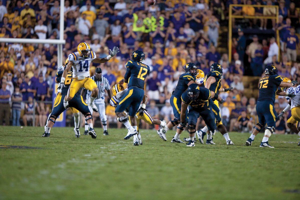 LSU freshman cornerback Tyrann Mathieu tries to tackle West Virginia sophomore quarterback Geno Smith during the Tigers&#8217; 20-14 win Saturday in Tiger Stadium.