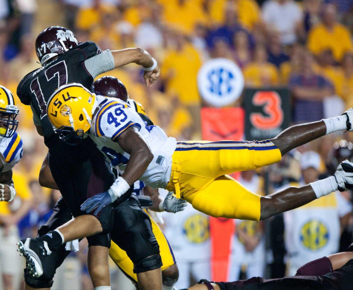 LSU redshirt freshman defensive end Barkevious Mingo (49) launches himself into Mississippi State quarterback Tyler Russell (17) during the Tigers&#8217; 29-7 win Sept. 18 against the Bulldogs. Mingo leads the team in quarterback hurries with four.