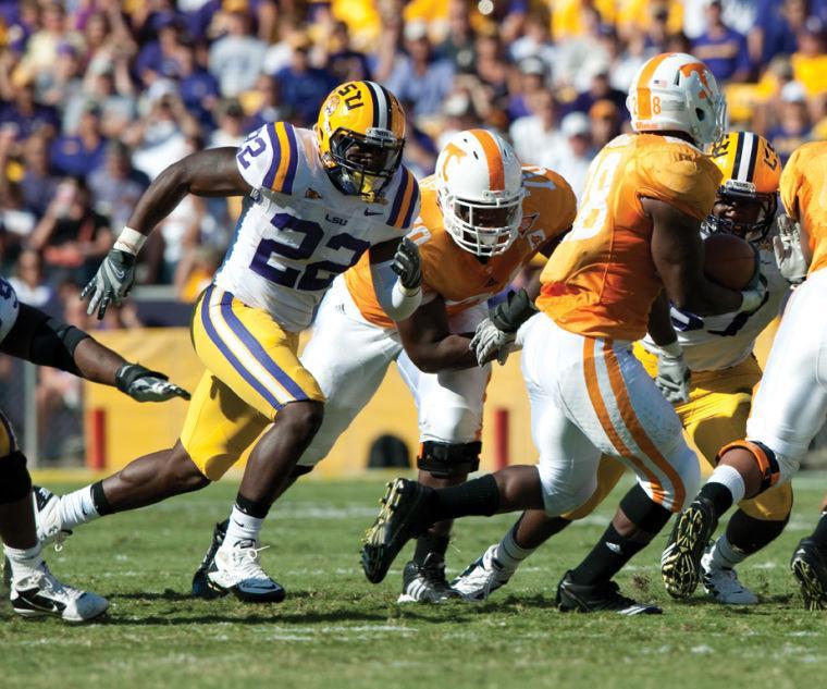 LSU junior linebacker Ryan Baker (22) chases after Tennessee running back Taurean Poole (28) in LSU's 16-14 win on Saturday.