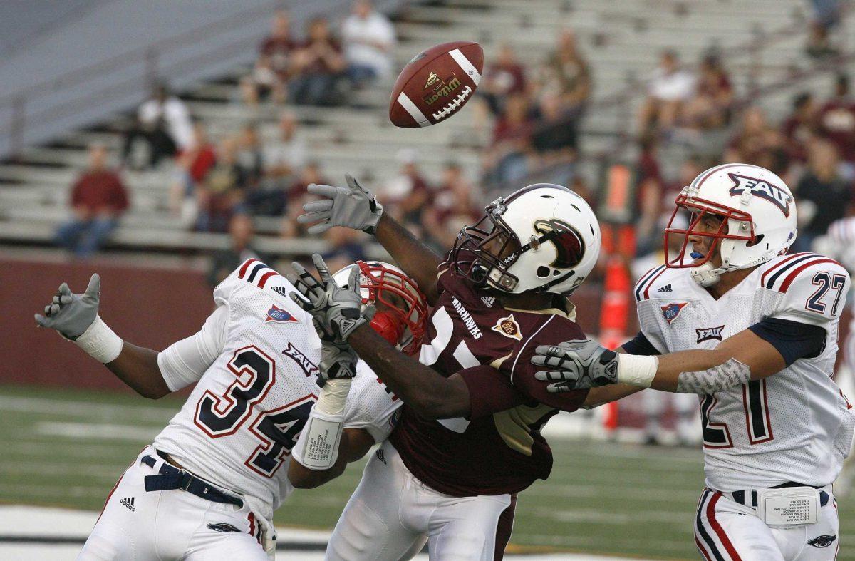 Louisiana-Monroe junior wide receiver Luther Ambrose (22) tries to catch the ball between Flordia Atlantic freshman defensive back Keith Reaser (34) and junior defensive back Marcus Bartels (27) on Oct. 9. The Warkhawks beat the Owls, 20-17, in Malone Stadium in Monroe.