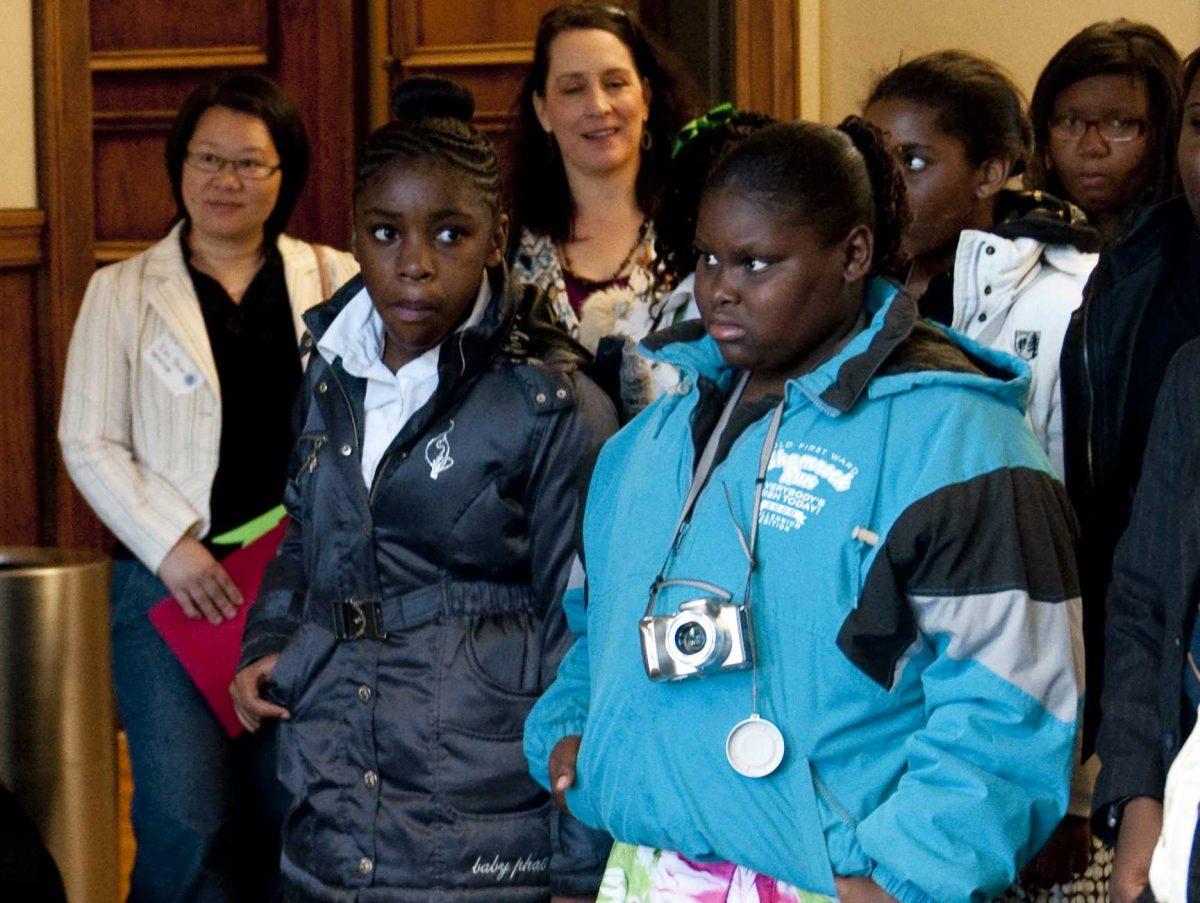 LSU Ambassadors, University students and local children tour the Journalism Building Friday during the School of Social Work's "Day of the Mentor" program.