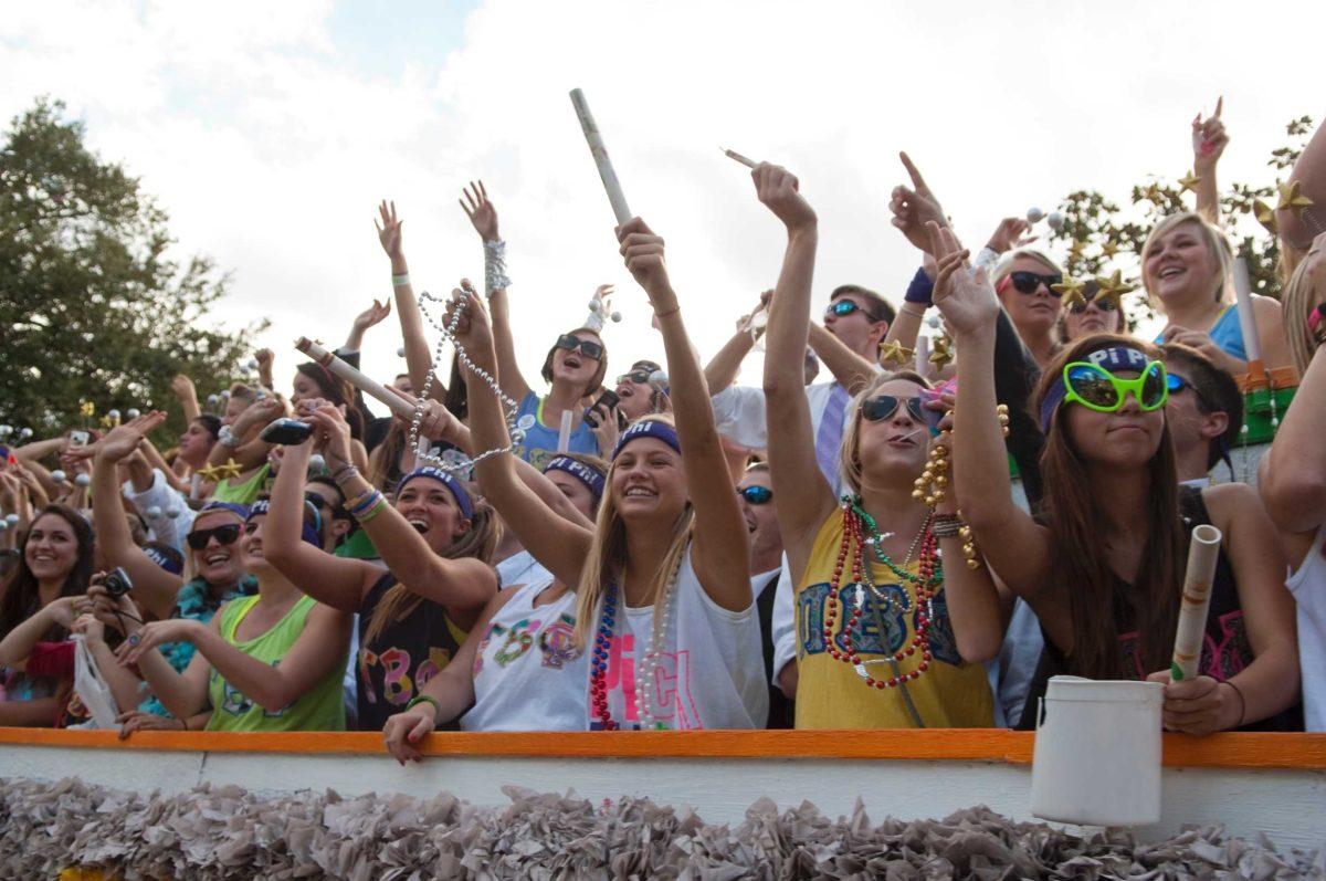 Members of the Phi Beta Phi sorority ride on their float and throw beads to the crowd Saturday in the Homecoming parade during the LSU Day and Homecoming festivities.