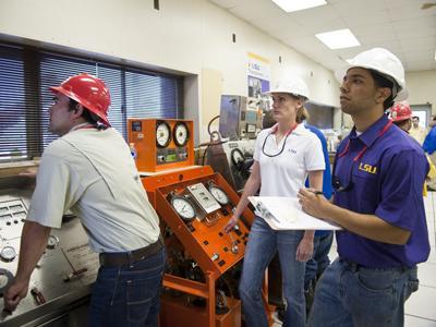 (Left to right) Petroleum engineering sophomore John Cleveland, sophomore Candice Miller and senior Hassan Ramzi work on a demonstration June 4 at the Petroleum Engineering Research and Technology Transfer Laboratory.