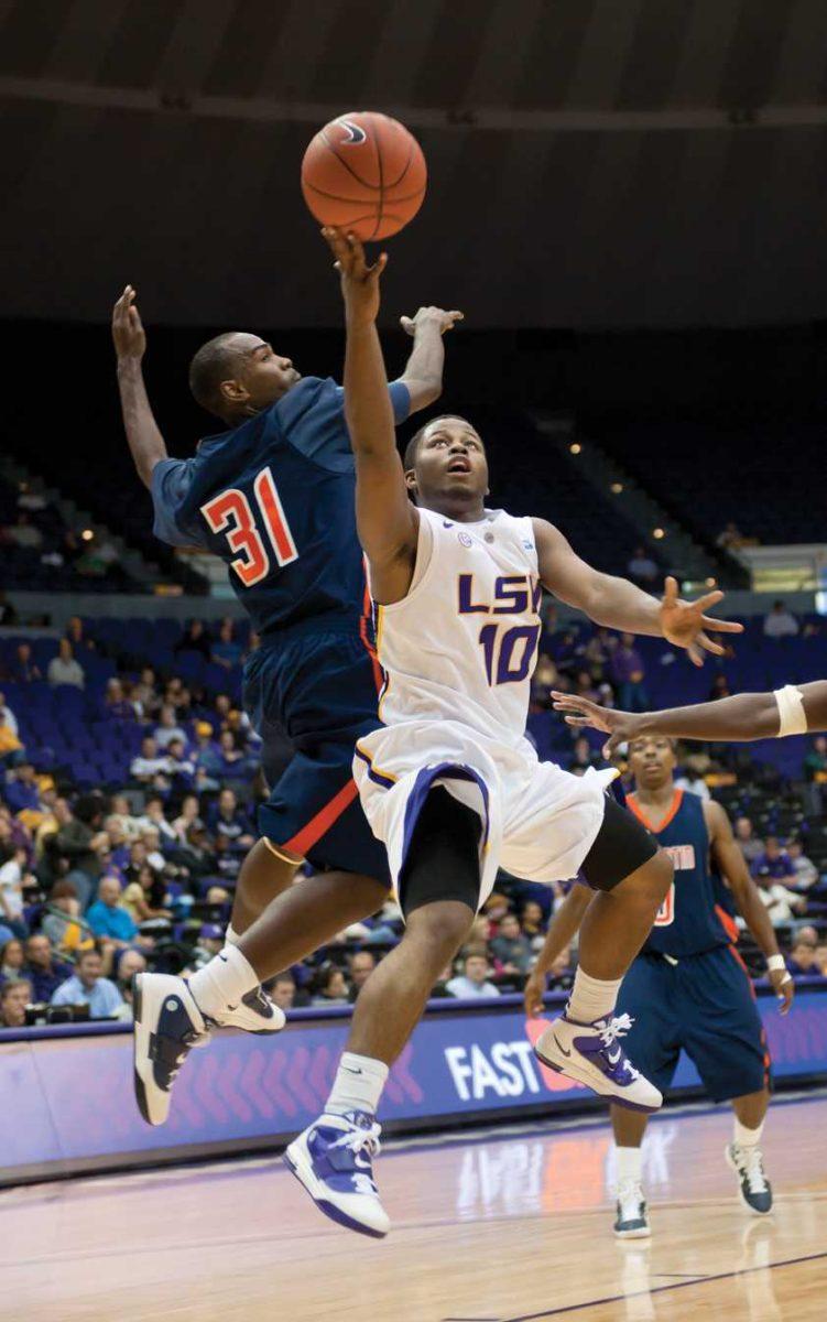 LSU freshman guard Andre Stringer (10) lays the ball up Nov. 18 as UT Martin junior guard Dane Smith defends during the Tigers&#8217; 79-56 win against the Skyhawks.