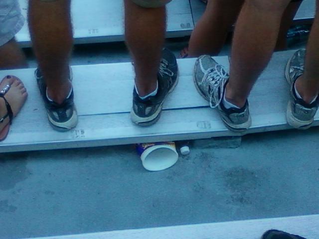 Students stand on cracked and broken bleachers to root on the Tigers.