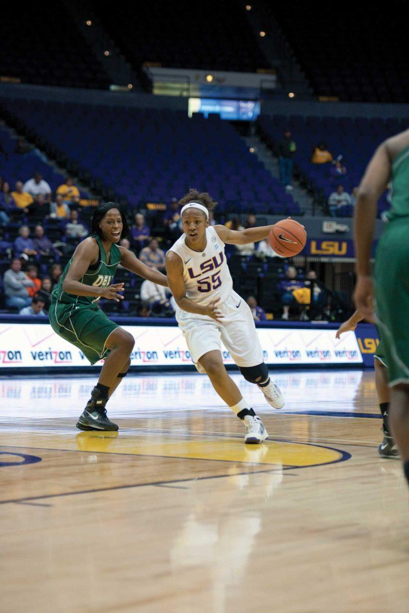 LSU junior forward LaSondra Barrett dribbles past Delta State senior forward Shameka Russell on Monday during the Tigers&#8217; 67-47 win.