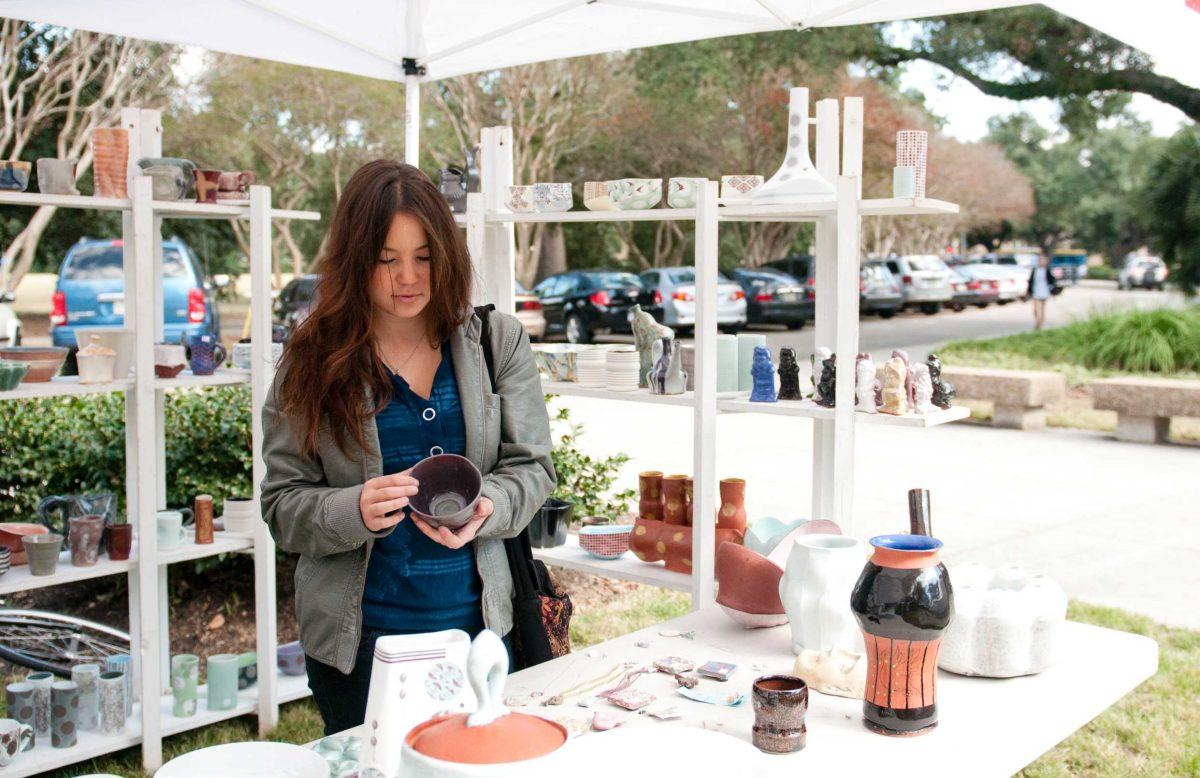 Stephanie Hedrick, English sophomore, shops for pottery and ceramics Tuesday at the Ceramic Arts Student Association&#8217;s biannual sale in front of the Student Union.