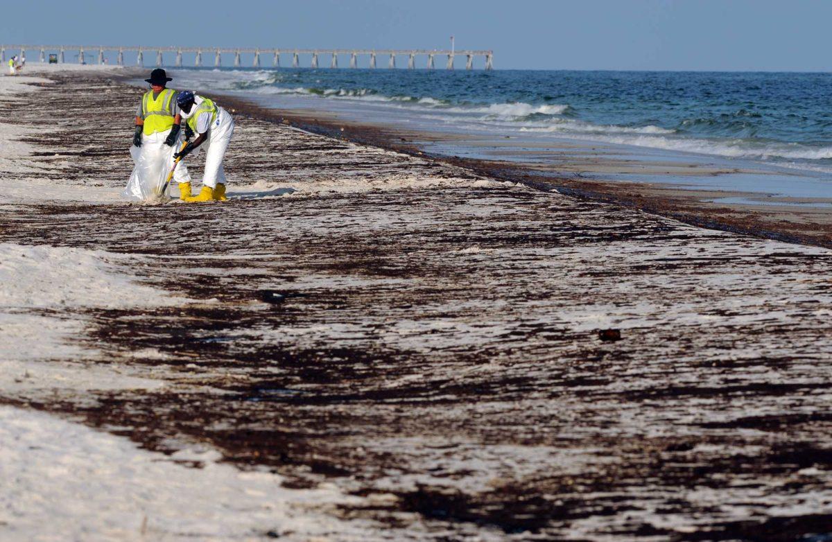 Crews work to clean up oil from the Deepwater Horizon oil spill washed ashore at Pensacola Beach in Pensacola Fla. In a reversal, the Obama administration says it will not pursue offshore drilling in East Coast waters, including the eastern Gulf of Mexico. A senior administration official told The Associated Press on Wednesday, Dec. 1,, 2010 that because of the BP oil spill, the Interior Department will not propose any new oil drilling in the East Coast for at least the next seven years.