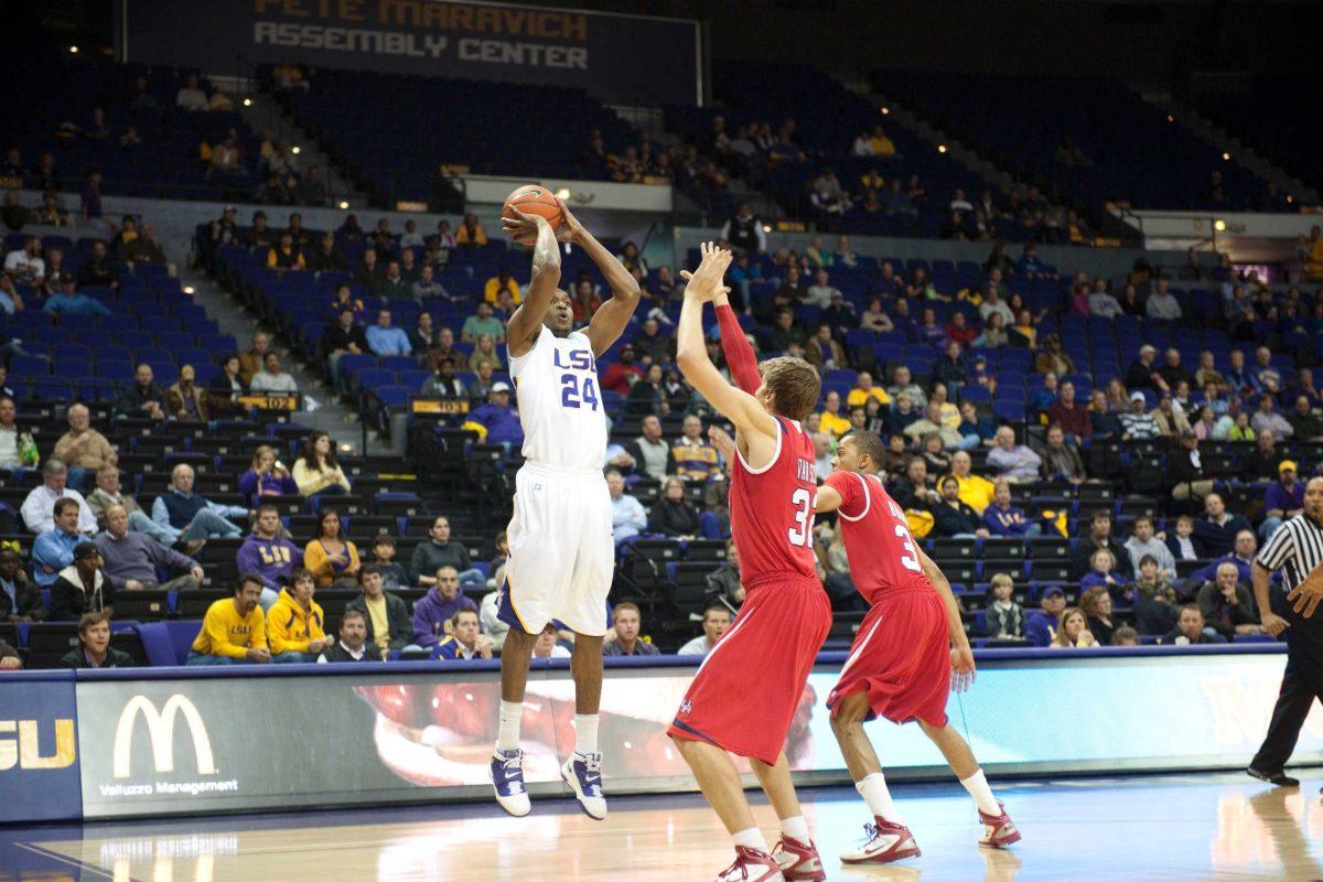 LSU junior forward Storm Warren attempts a 3-point shot during the Tigers&#8217; 73-57 win against Houston on Tuesday in the PMAC. Warren had a double-double with 12 points and 11 rebounds.