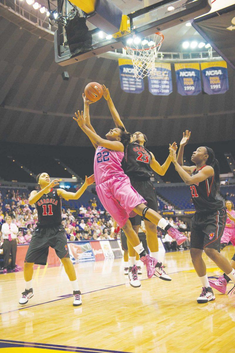 LSU junior forward Courtney Jones (22) moves past Georgia defenders Sunday to make a shot during the Tigers&#8217; 47-41 victory against the Bulldogs in the PMAC.