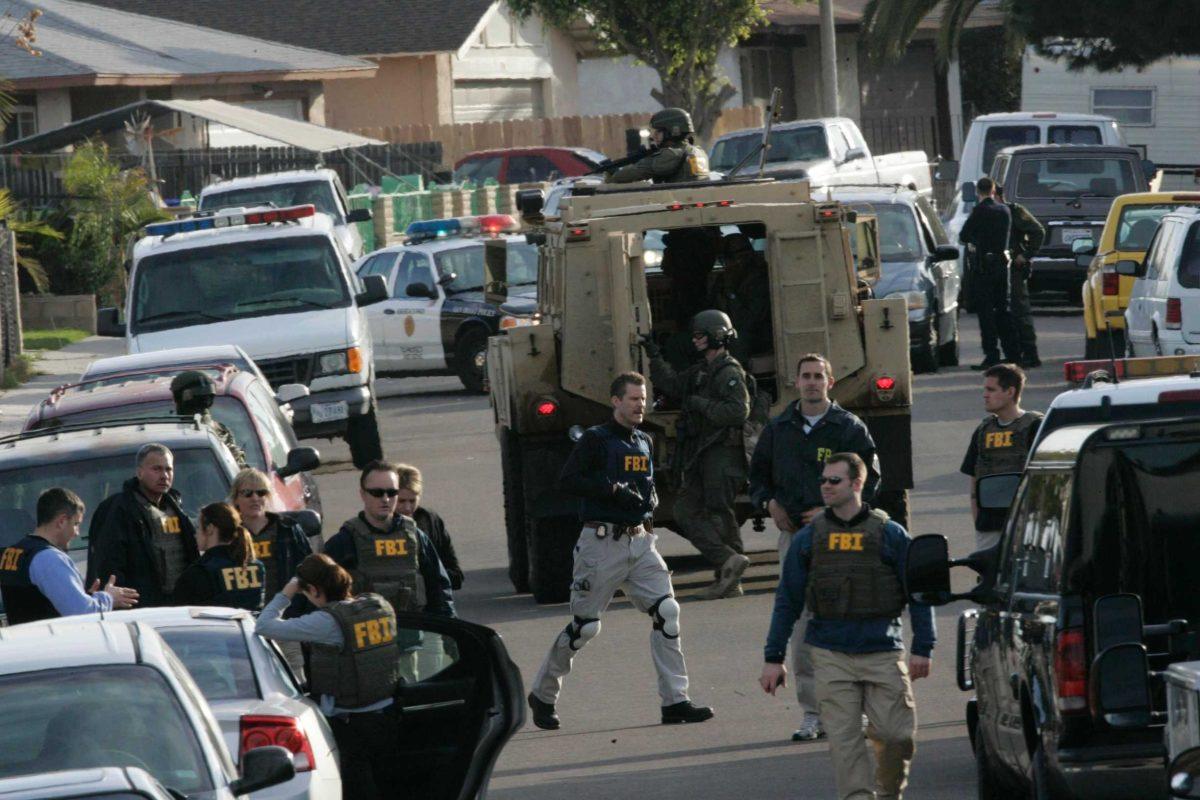 FBI agents execute a search warrant in the San Ysidro area of San Diego on Tuesday, Jan. 11, 2011. Prosecutors say a U.S. Border Patrol agent charged with harboring illegal immigrants, including his deported father, had a secret underground bunker behind his San Diego-area home. Assistant U.S.