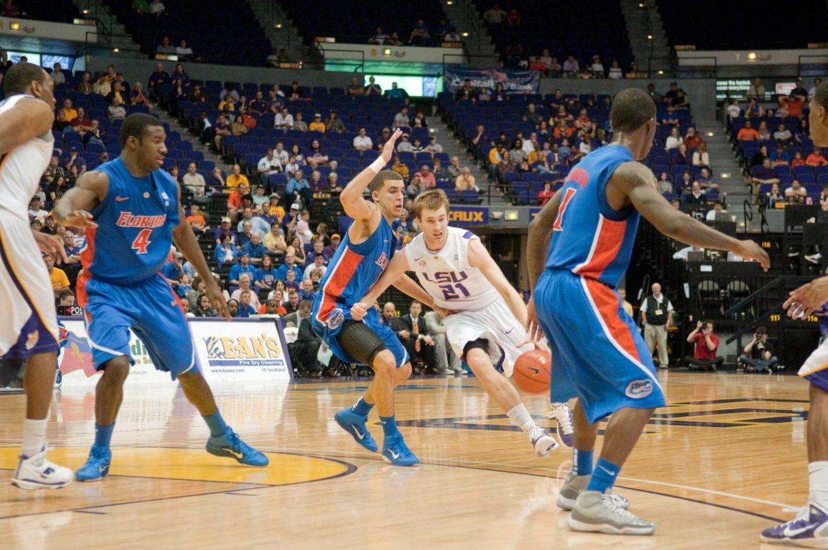 Freshman guard Matt Derenbecker drives past a Florida defender on Feb. 20 in LSU&#8217;s 68-61 loss against Florida. Derenbecker&#8217;s personality has made him a team standout.