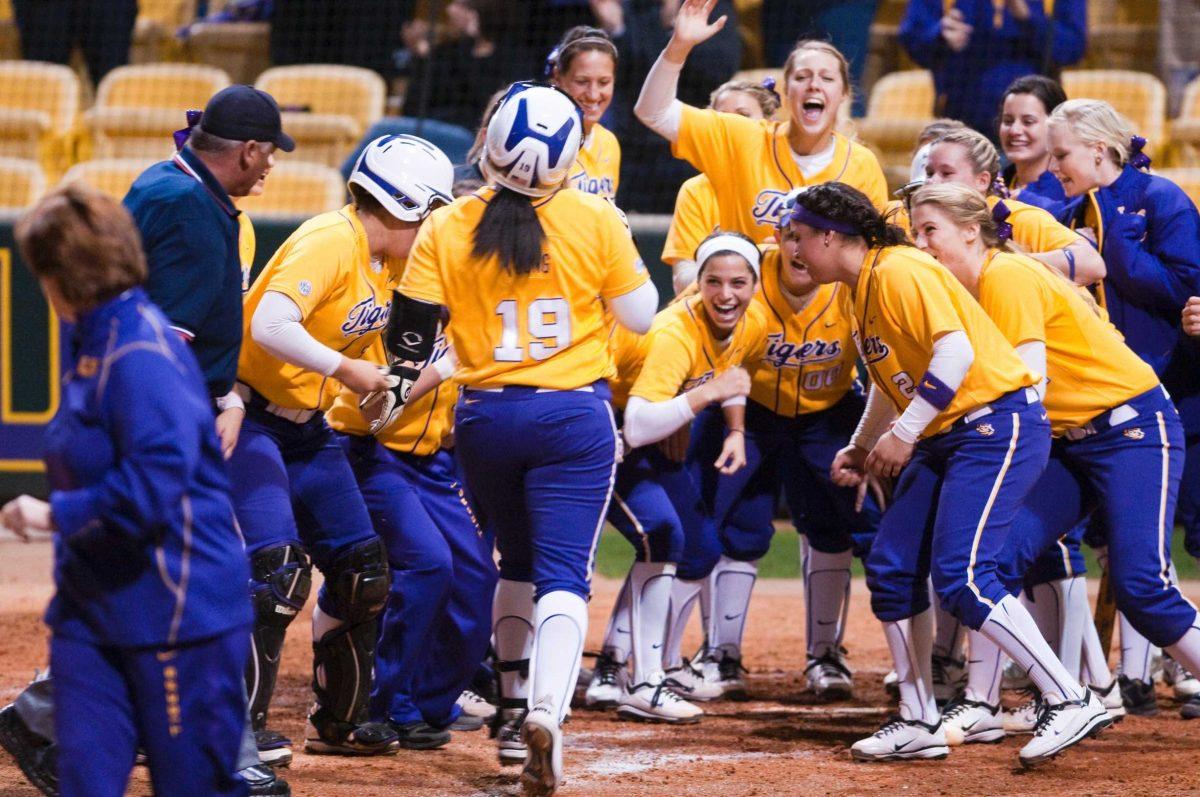 <p>The LSU softball team celebrates Wednesday after LSU junior infielder Anissa Young (19) hit a home run. The Tigers defeated Southeastern Louisiana, 9-0, in five innings.</p>