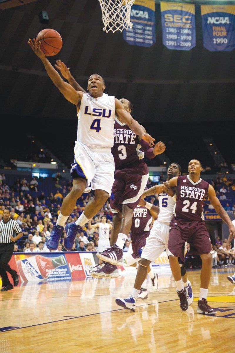 LSU junior guard Chris Bass (4) jumps for a shot Saturday during the Tigers&#8217; 58-57 loss against Mississippi State in the PMAC. The loss was LSU&#8217;s fifth in a row.