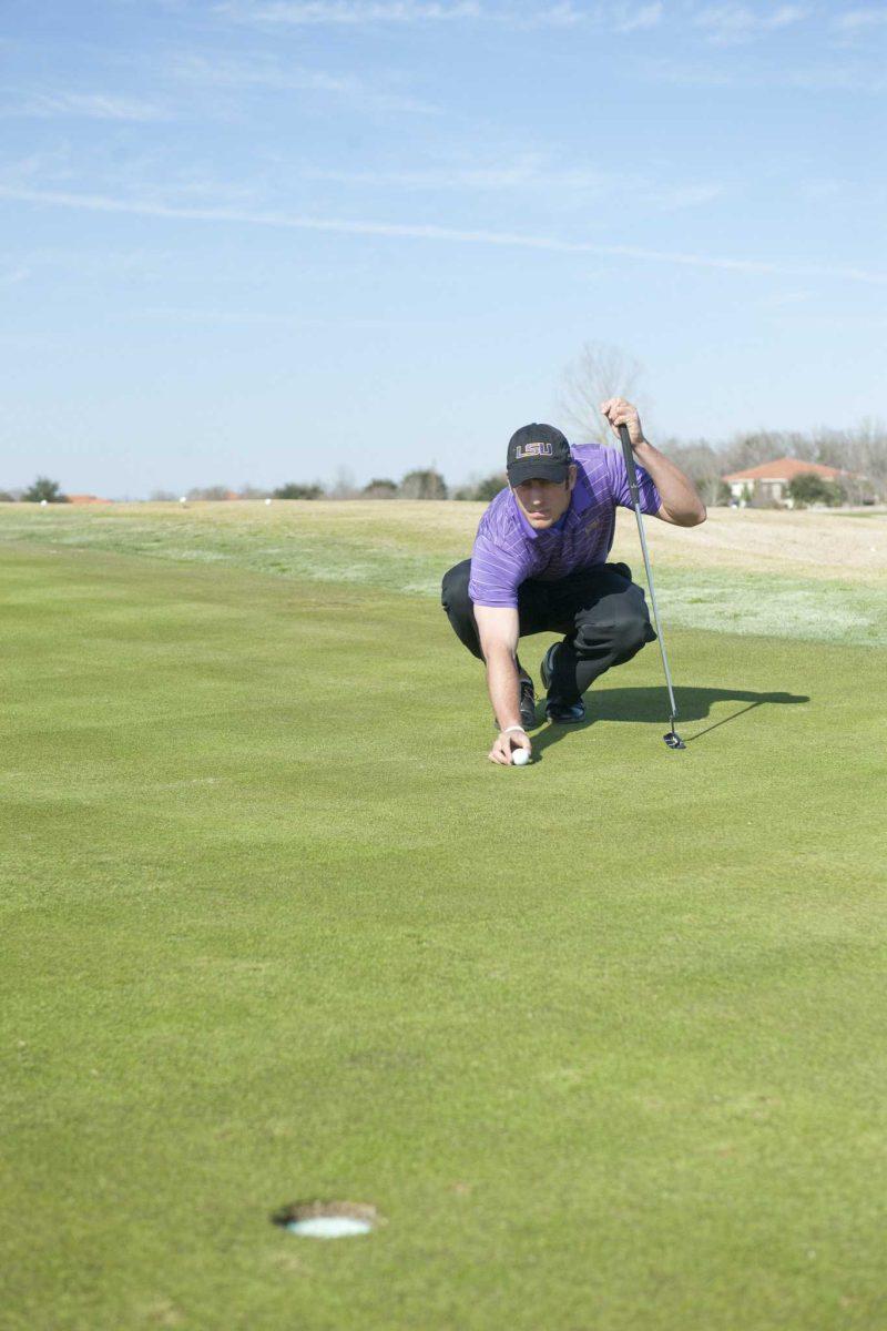 LSU senior Andrew Loupe lines up a putt during practice Feb. 8 at the University Club.