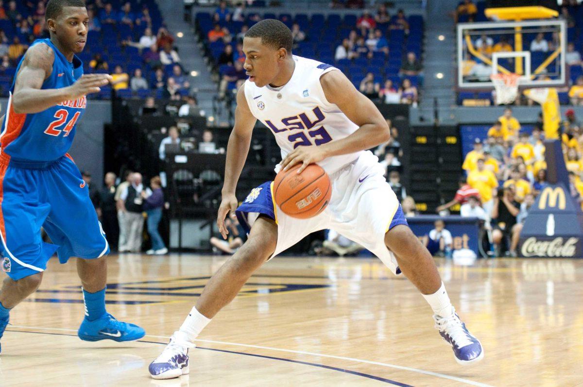 LSU freshman guard Ralston Turner tries to dribble past a Florida guard Sunday during the Tigers&#8217; 61-68 loss to the Gators in the PMAC. It was the 10th-straight loss for LSU.