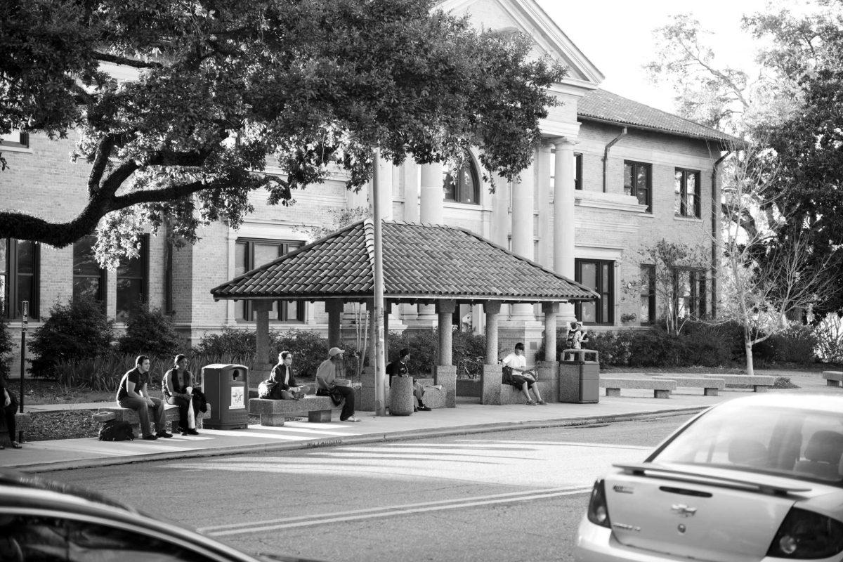 Students wait in front of the Journalism Building for the Tiger Trails buses. There are plans to build a sheltered bus stop across the street.