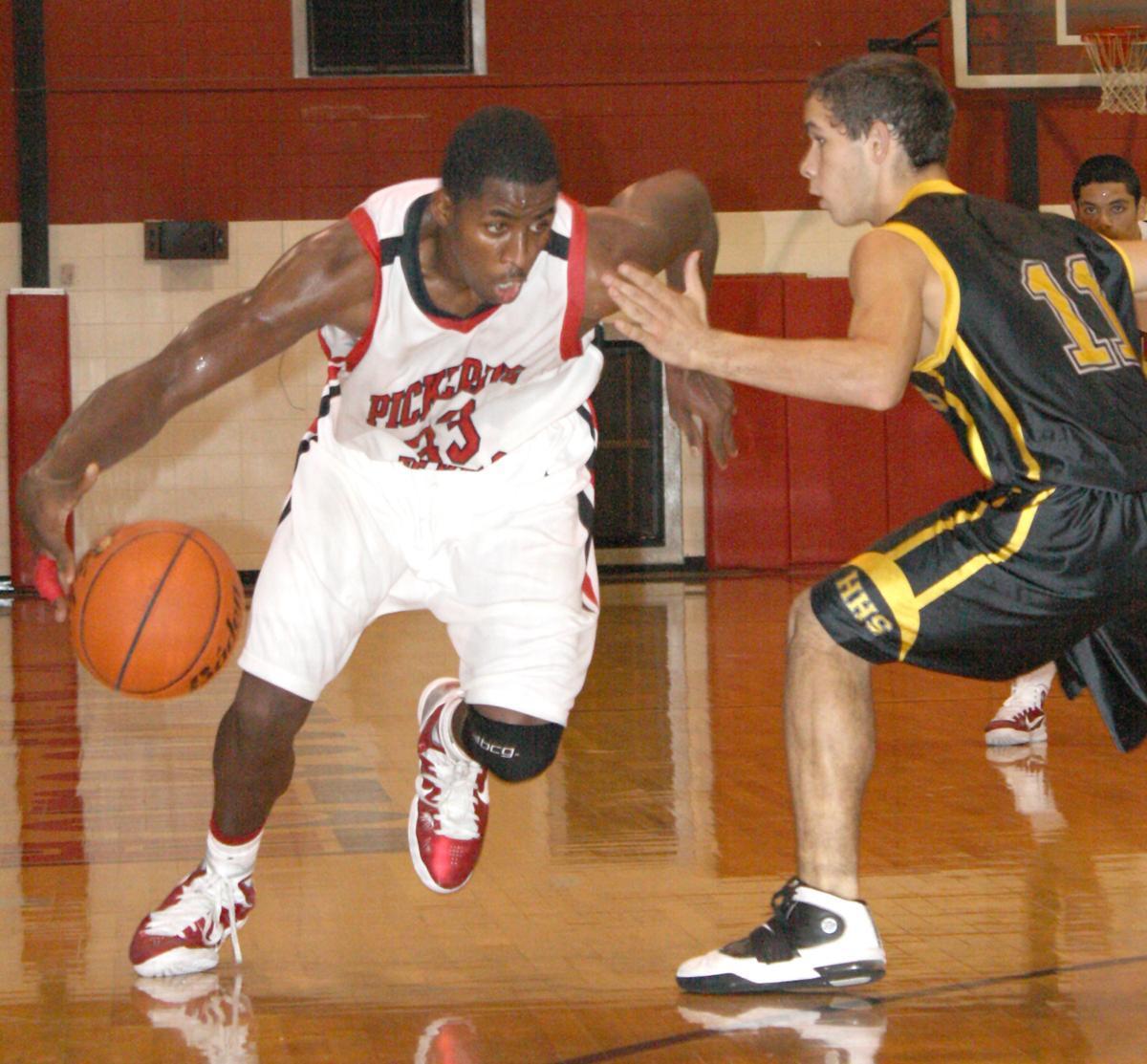 Pickering High School guard John Isaac dribbles past a defender Nov. 27. Isaac, who tore his ACL, says he is at full strength.