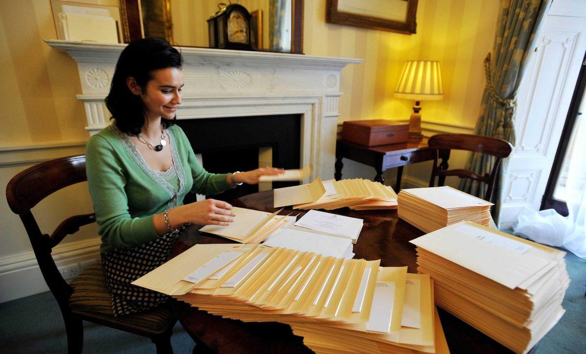 A member of the Lord Chamberlain&#8217;s Office places invitations to the royal wedding into envelopes Wednesday at Buckingham Palace in London.