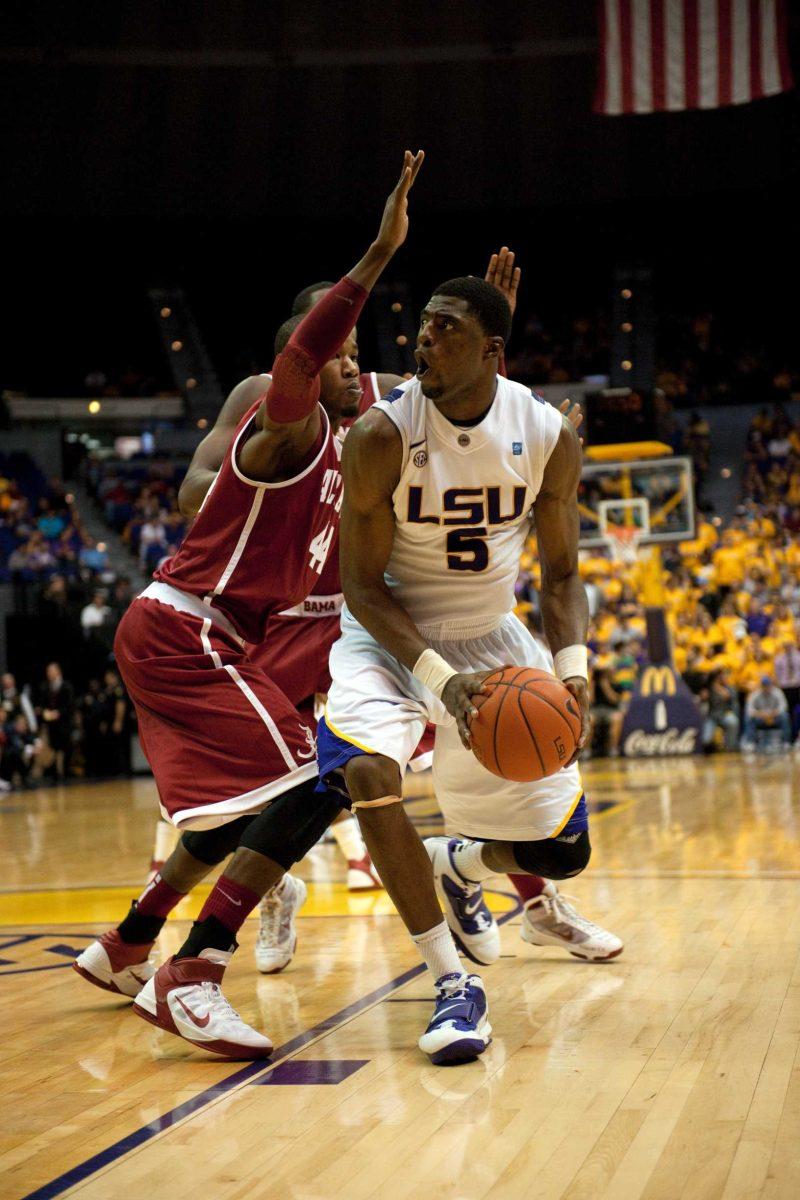 LSU junior forward Malcolm White shoulders a defender Thursday during the Tigers&#8217; 67-56 loss against the Alabama Crimson Tide in the PMAC.