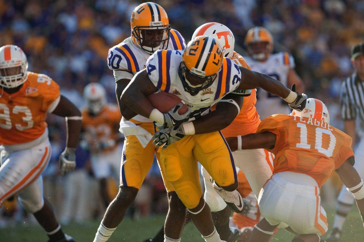 Former LSU running back Stevan Ridley (34) tries to break a tackle in the Tigers&#8217; 16-14 win Oct. 4 against the Volunteers. Ridley, fellow former Tiger Terrence Toliver (80) and other former LSU players await the fate of the NFL lockout.