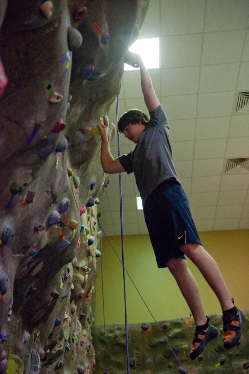 Connor Sinclair, biological engineering freshman, climbs Wednesday at the UREC climbing gym.