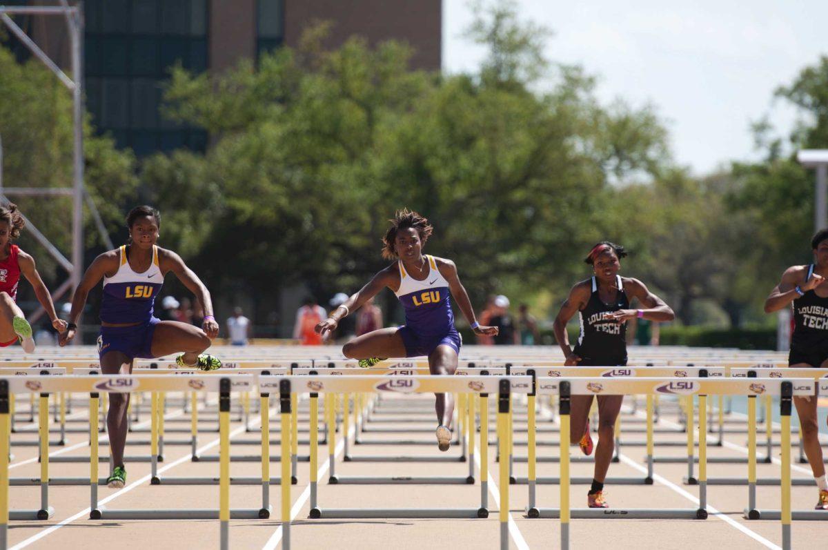 LSU freshman Jasmin Stowers, left, and senior Tenaya Jones sprint Saturday in the 100 meter hurdles at the LSU Relays. The Tigers nearly swept the relay events.