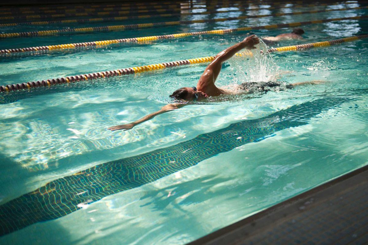 Graduate student Michael Bitton swims Thursday at the UREC Student Recreation Complex Pool. Bitton is rehabilitating from injuries he sustained in an accident in May.