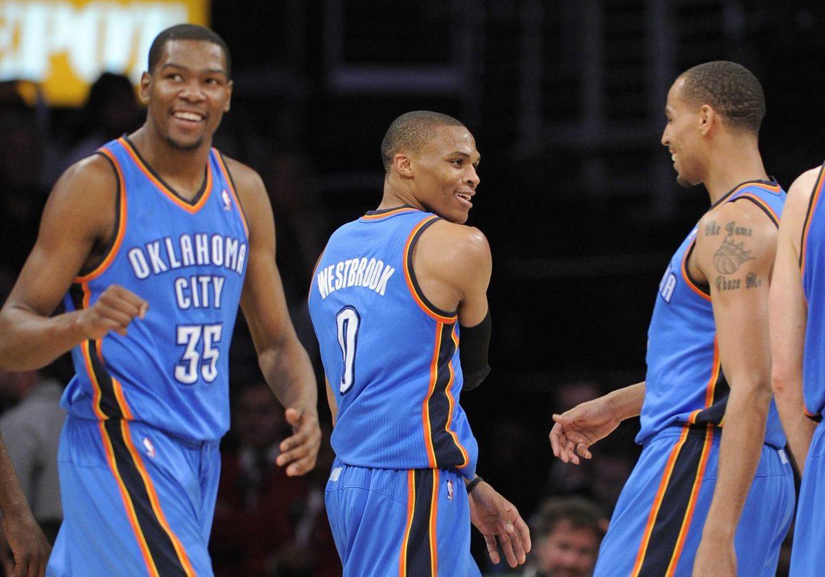 Oklahoma City Thunder forward Kevin Durant (35), guard Russell Westbrook (0) and guard Thabo Sefolosha, right, celebrate a 120-106 win against the Lakers on Sunday.