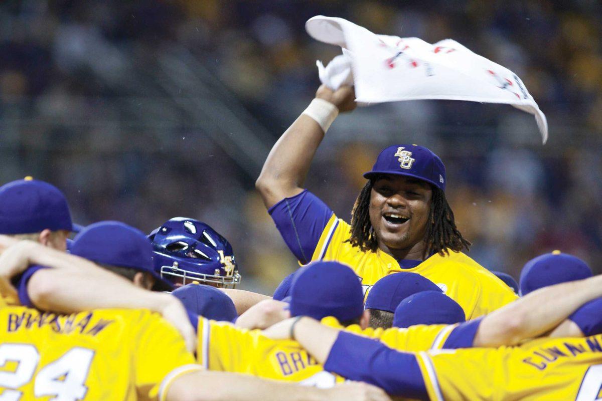 LSU baseball players huddle together while freshman outfielder Spencer Ware hypes up his teammates Feb. 18 before the season opener against Wake Forest. LSU won, 15-4.