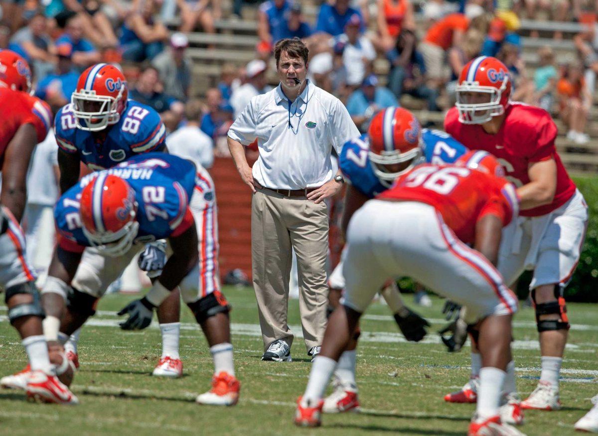 Florida football coach Will Muschamp, center, watches his team Saturday during the Orange and Blue spring game, which was beset by quarterback issues.