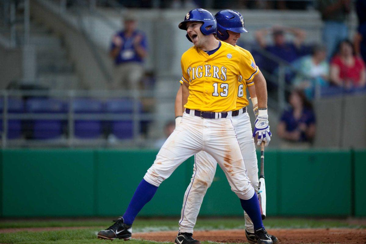 Sophomore infielder Alex Edward (13) celebrates a run in Tuesday&#8217;s game against Nicholls State in Alex Box Stadium. Edward slammed a two-run homer to left field during the Tigers&#8217; 12-3 win.