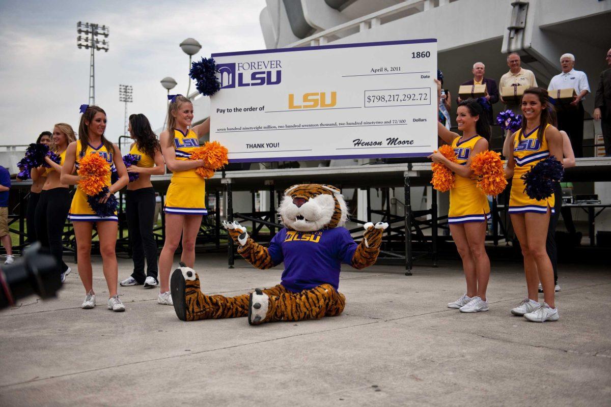 Mike the Tiger and LSU cheerleaders celebrate the Forever LSU campaign surpassing its $750 million fundraising goal during a block party Friday in front of the PMAC.