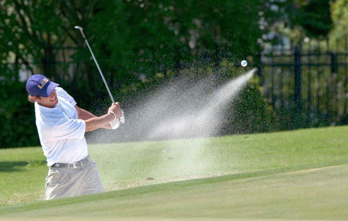 LSU senior Andrew Loupe hits out of a sand trap onto the green of the 10th hole Saturday during the LSU National Invitational at the University Club.