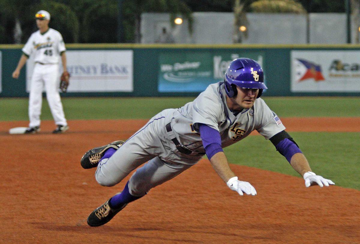 LSU&#8217;s Alex Edward dives into third base Tuesday for a one-run triple during the Tigers&#8217; 7-5 win at Turchin Stadium against the Tulane Green Wave.