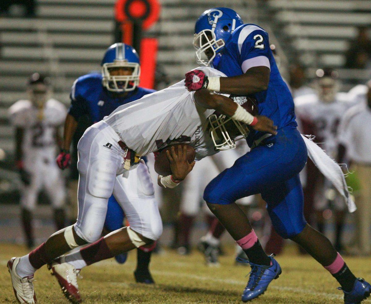 White Castle quarterback Ronald Martin tries to power through West St. John&#8217;s Ronnie Feist (2) on Oct. 22, 2010. Feist is one of two friends who committed to LSU together.