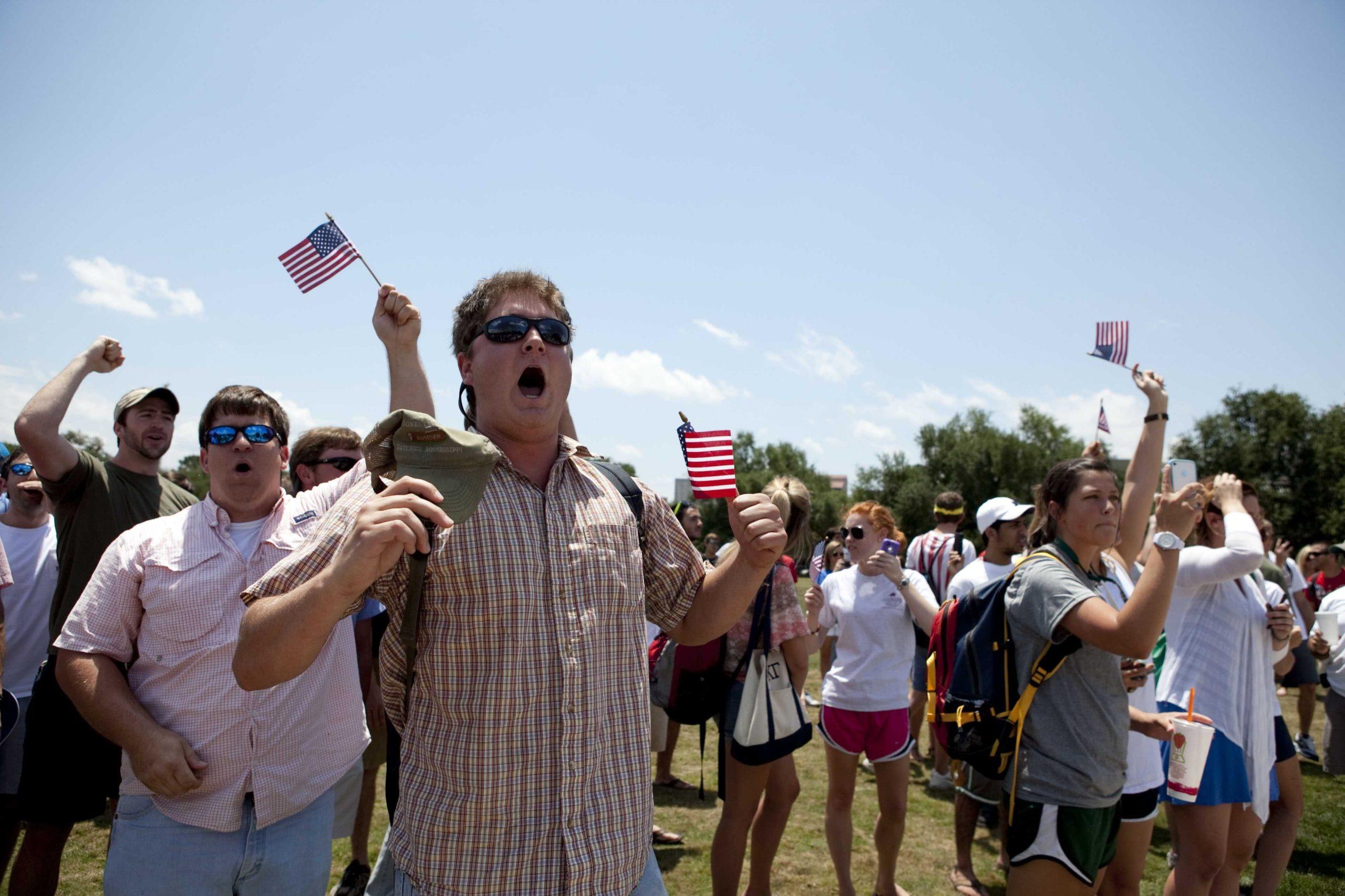 Angry crowd swarms for scheduled flag burning