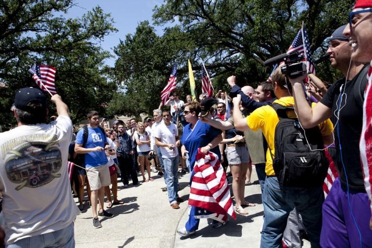 Angry crowd swarms for scheduled flag burning