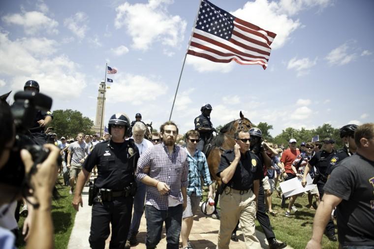 Angry crowd swarms for scheduled flag burning