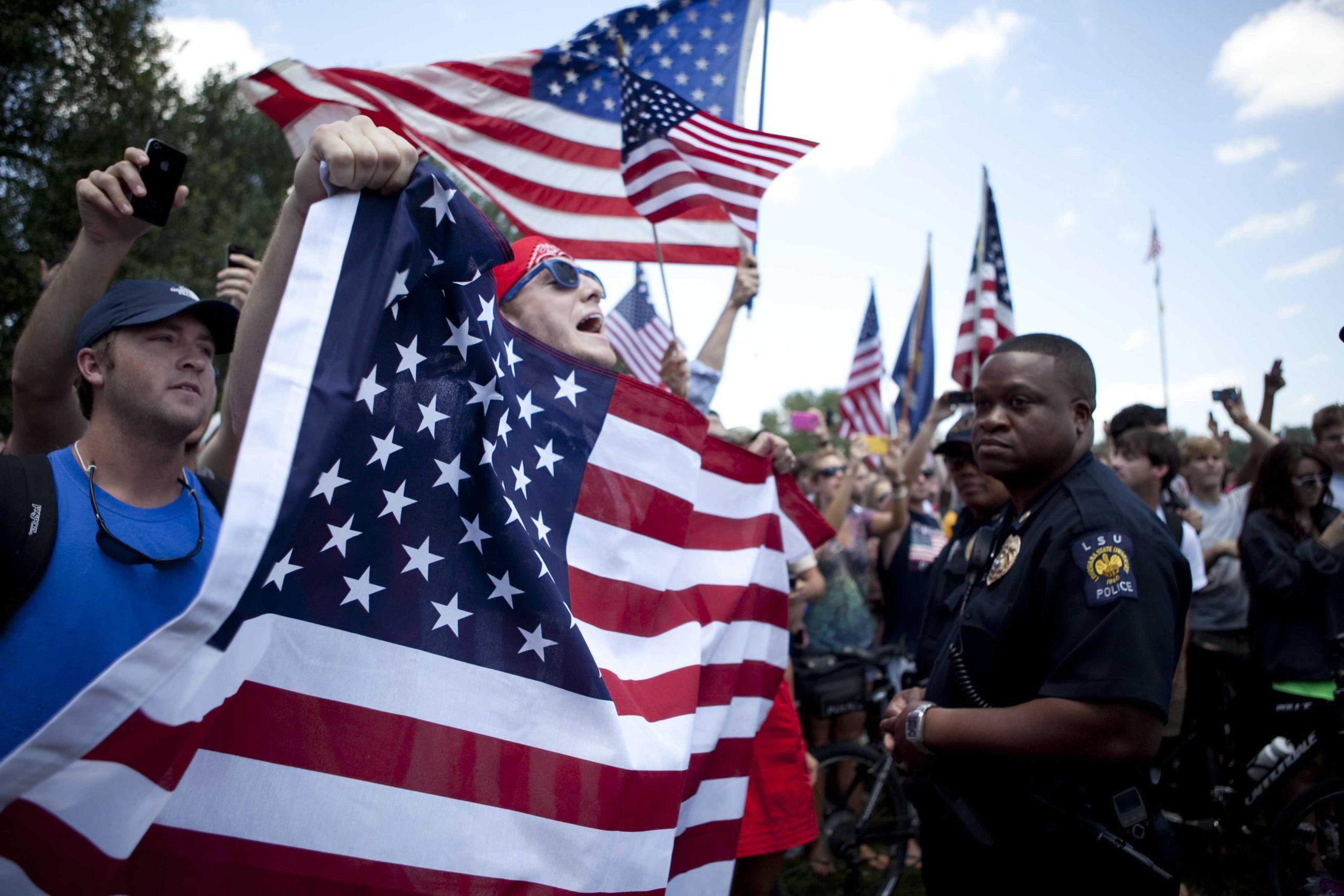 Angry crowd swarms for scheduled flag burning