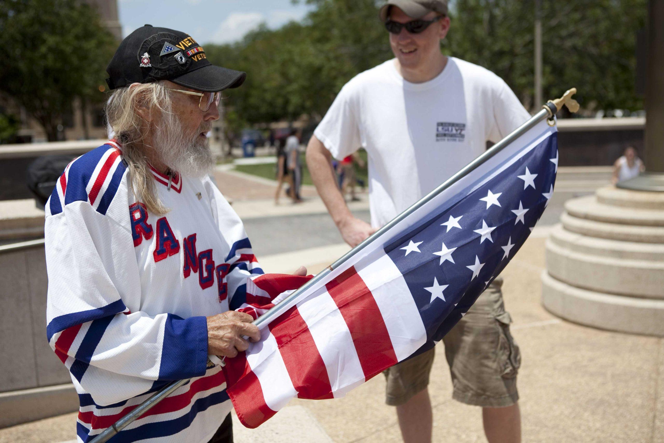 Angry crowd swarms for scheduled flag burning