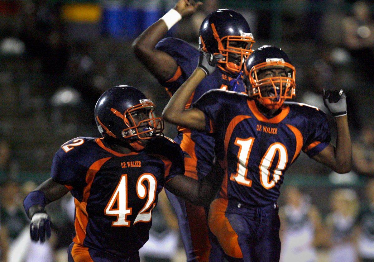 O. Perry Walker High School&#8217;s Dwayne Thomas (10) celebrates with teammates after he intercepted a pass against Archbishop Shaw High School at Behrman Stadium in Algiers on Friday, Oct. 3, 2008.