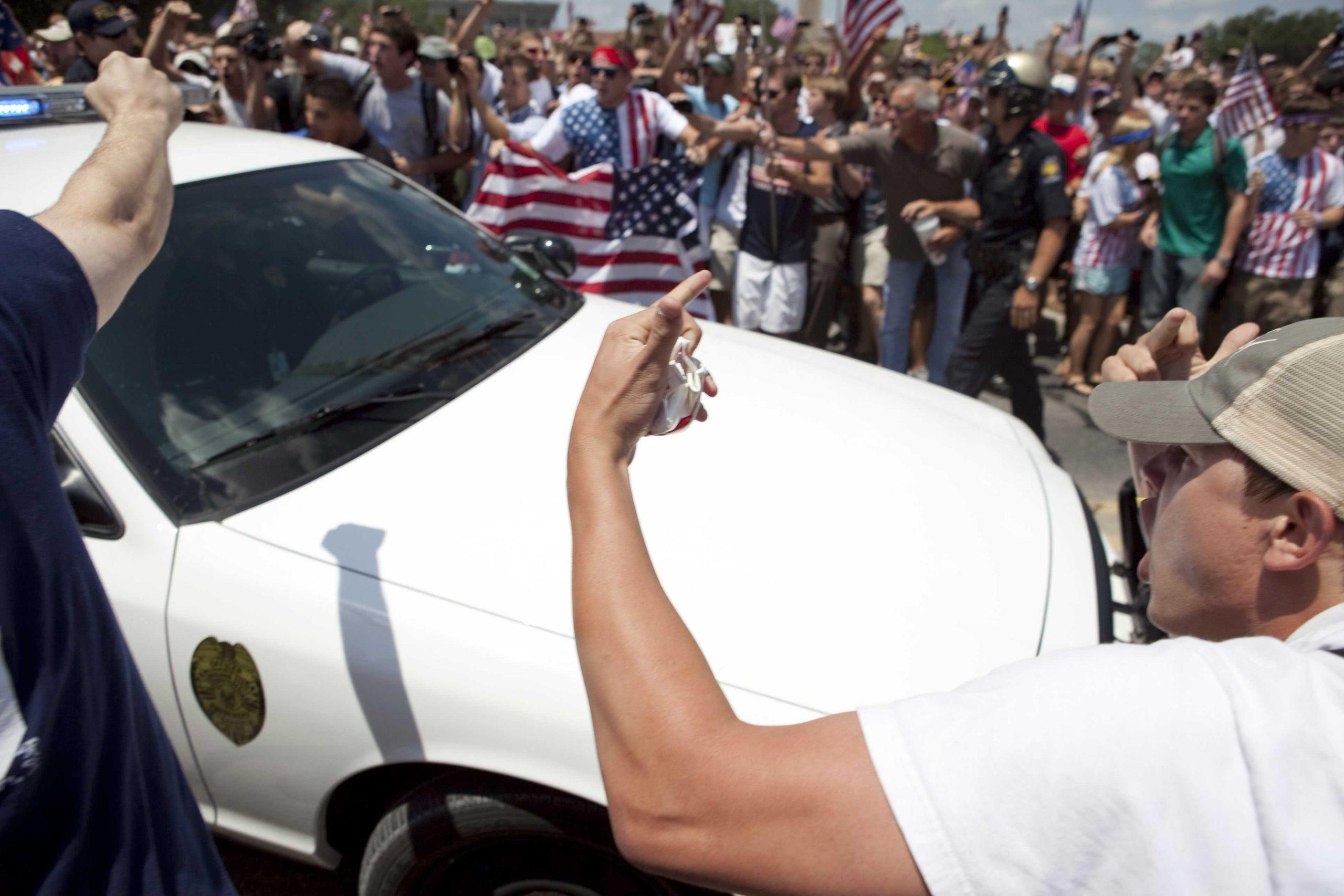 Angry crowd swarms for scheduled flag burning