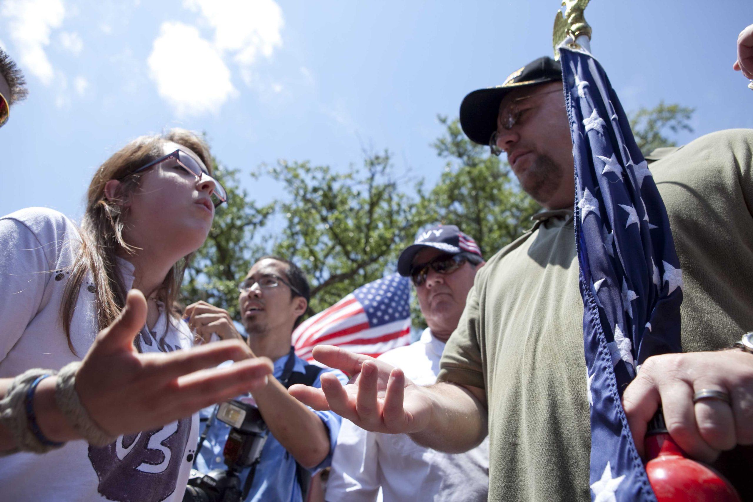 Angry crowd swarms for scheduled flag burning